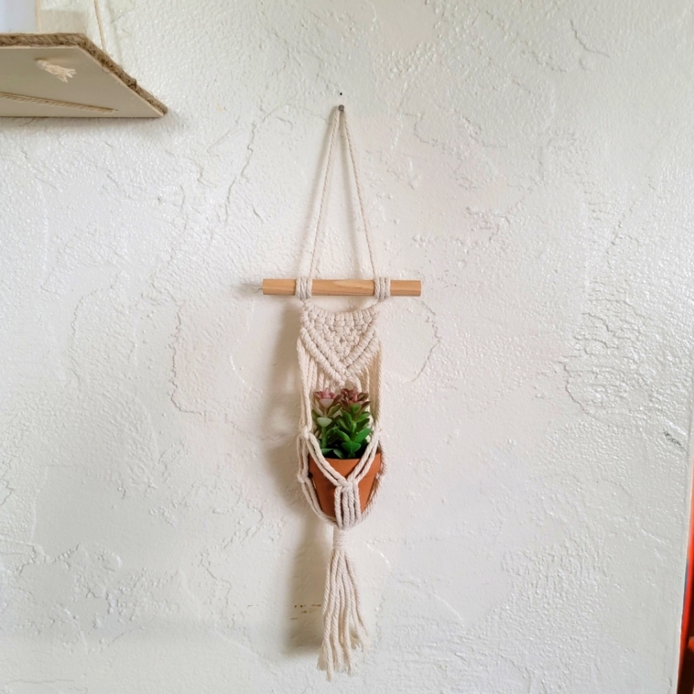 Faux plant in hanger.